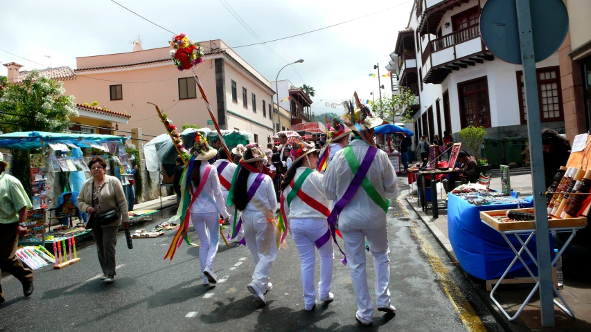 people in colorful outfits walking on the street