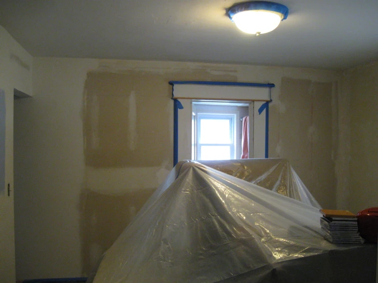 a room that is under construction with plastic coverings