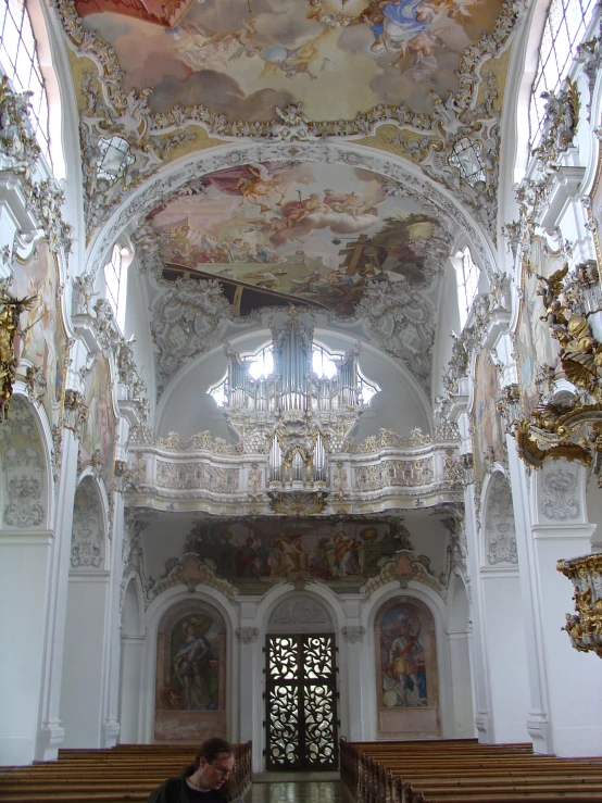 a church interior with an ornate vaulted ceiling