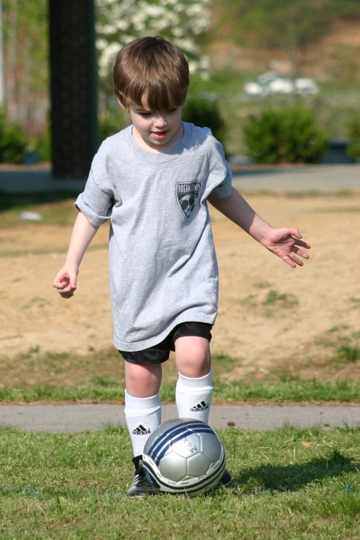 a  is kicking a soccer ball