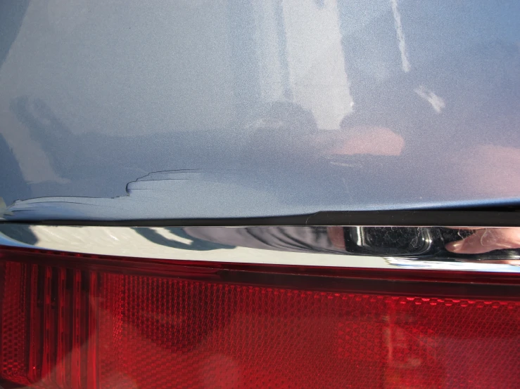 a close up of the tail lights of a blue car