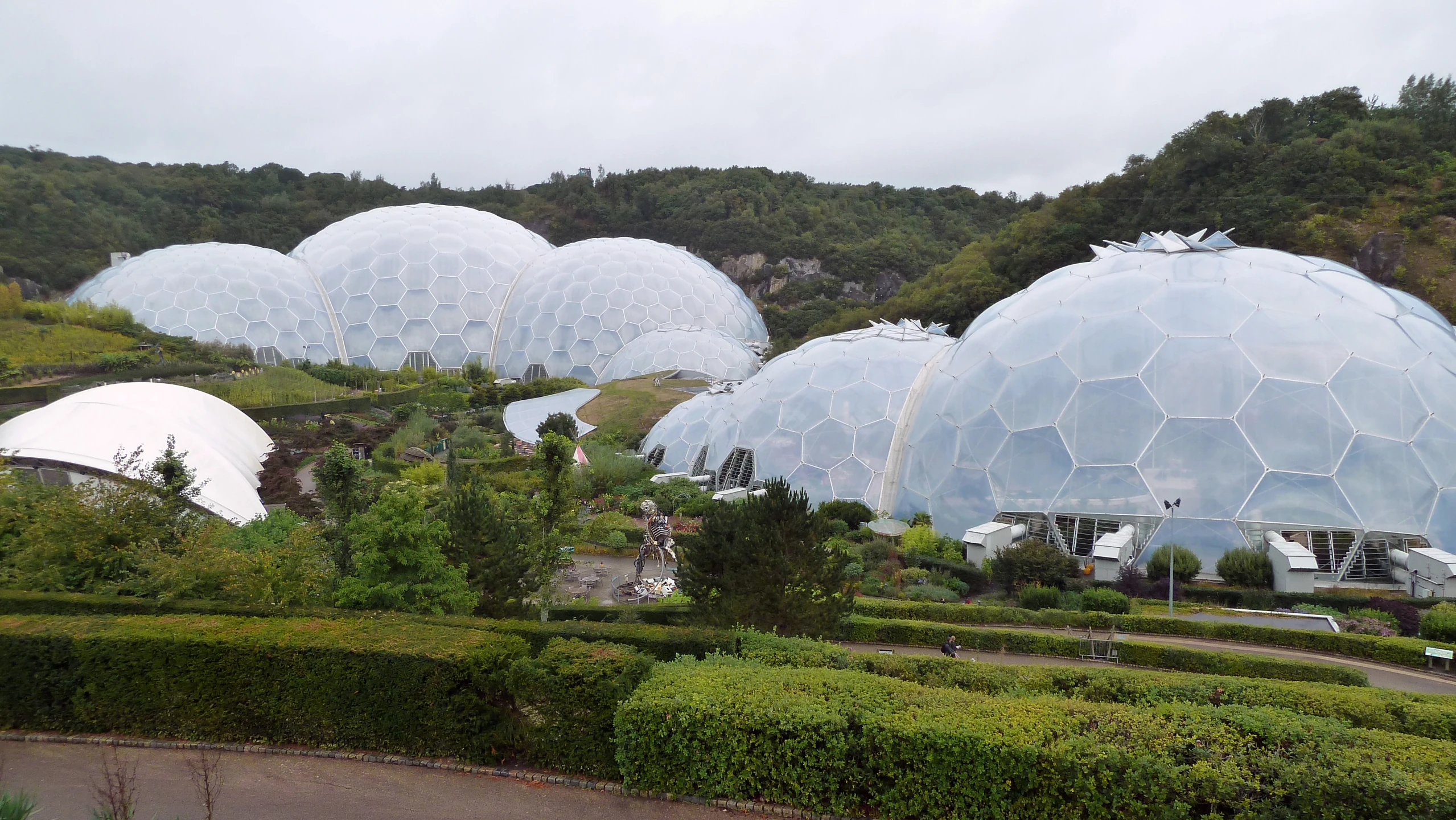 several large domes are in the middle of a garden