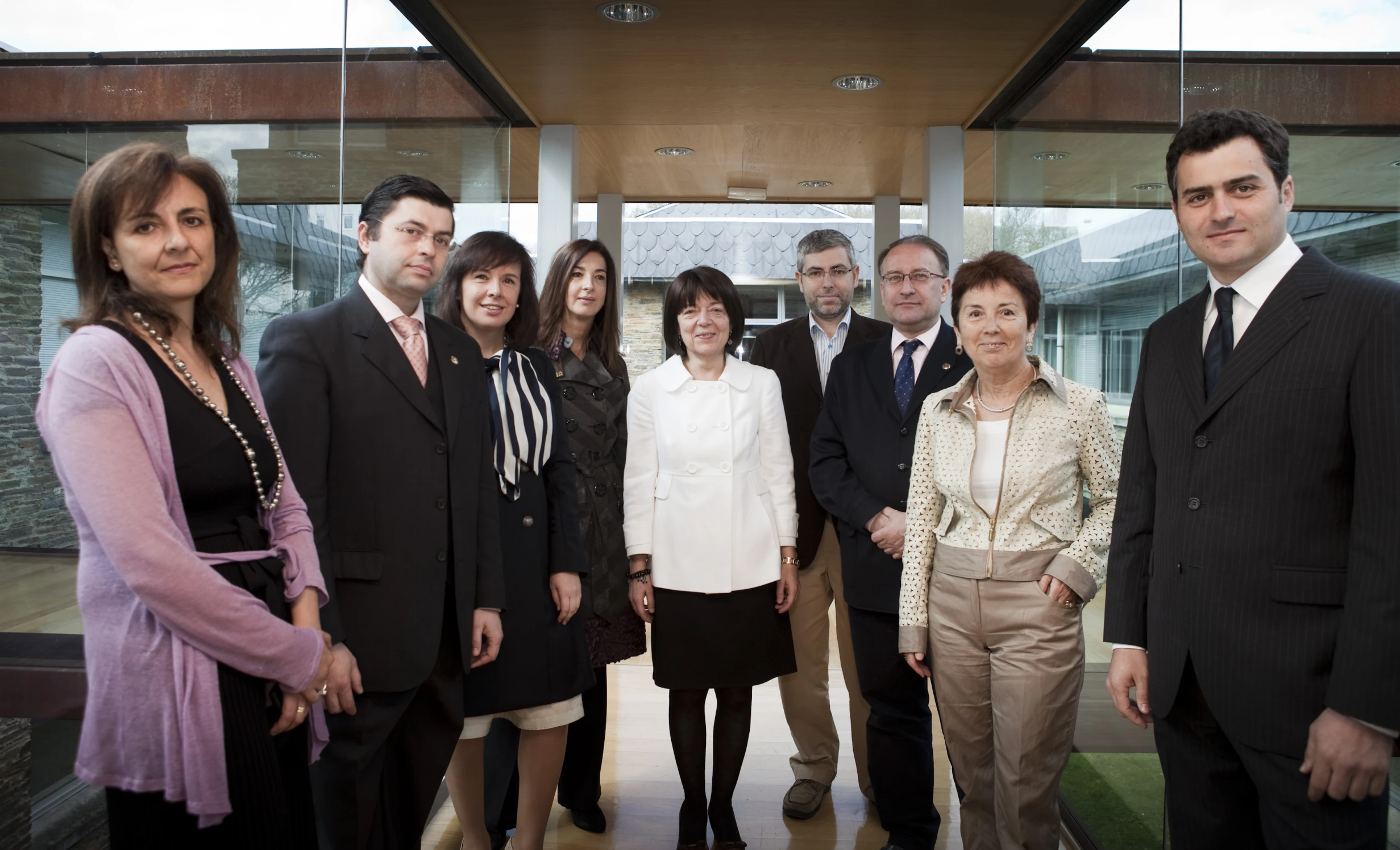 a group of people in business suits and ties are posing for a picture