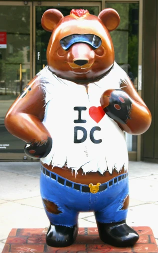 a statue of a bear wearing sunglasses and holding a pair of boxing gloves