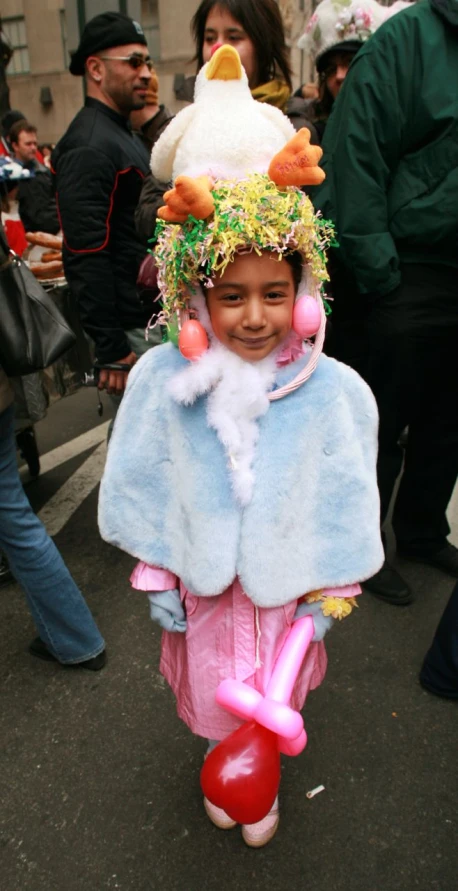 a little girl wearing an easter costume with a ducky hat
