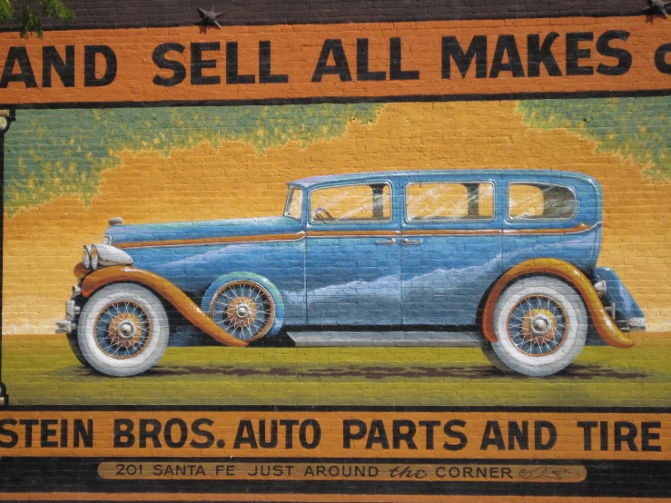 a large blue car sitting on top of a wall