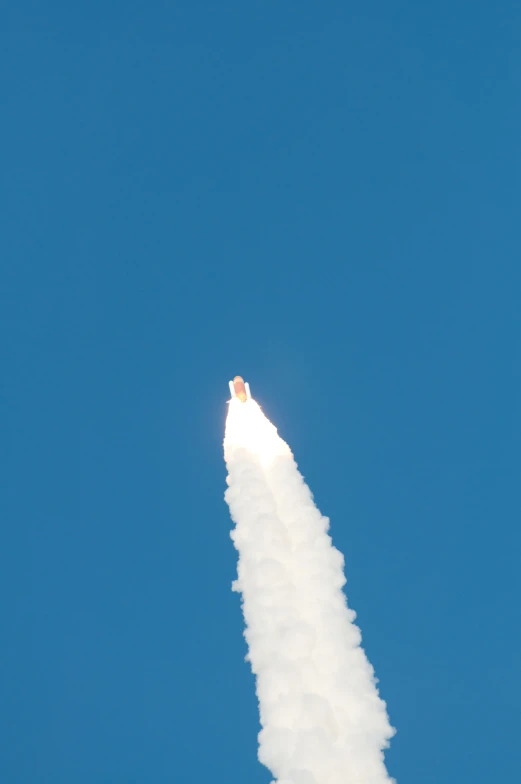 a contrail flying through the air on a clear day