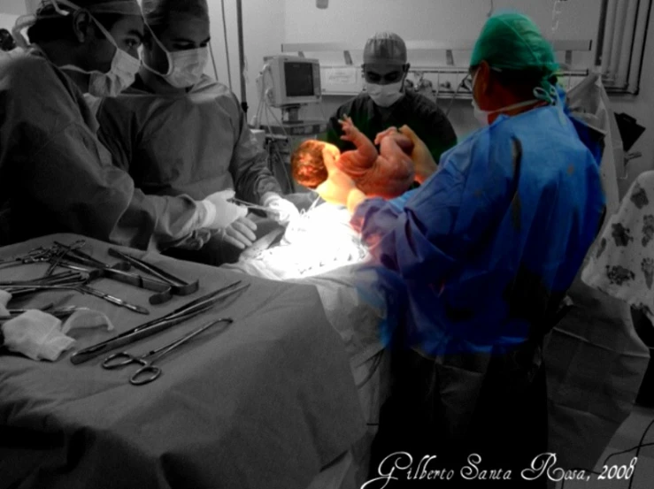 a group of doctors performing  on two men in a operating room