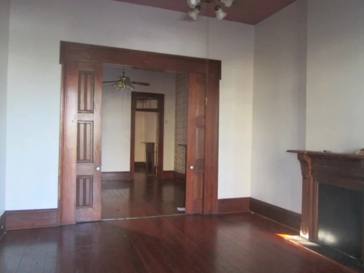 a room with hardwood floors and a fireplace