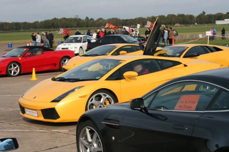 a group of different vehicles are parked in a parking lot