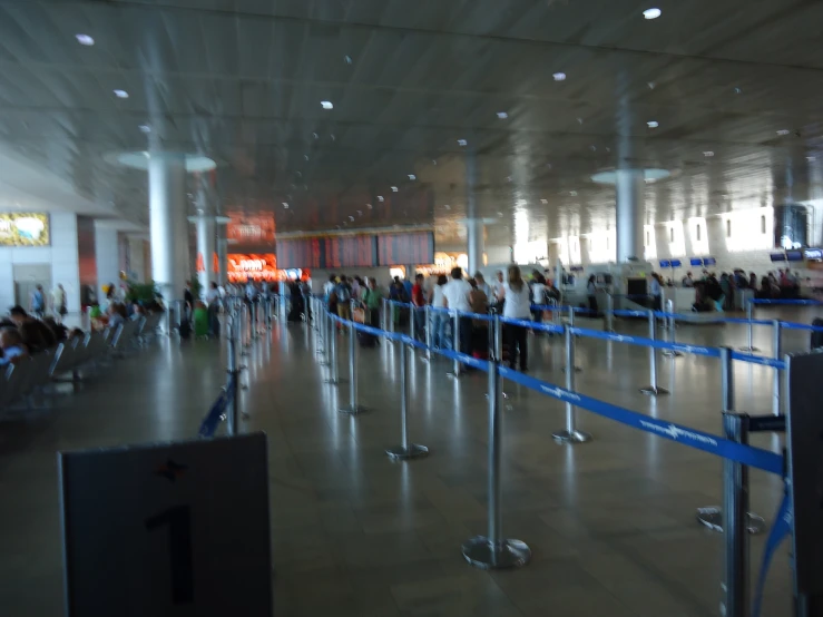 a row of blue turns for passengers at an airport