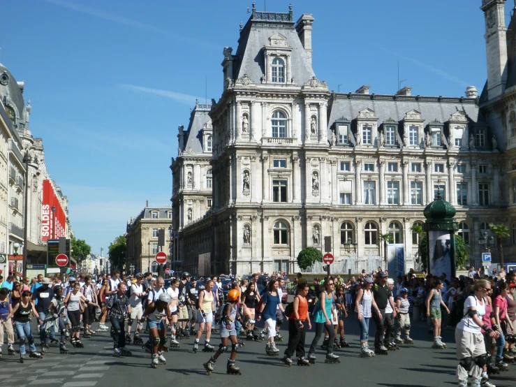 people walking and riding skate boards down the street