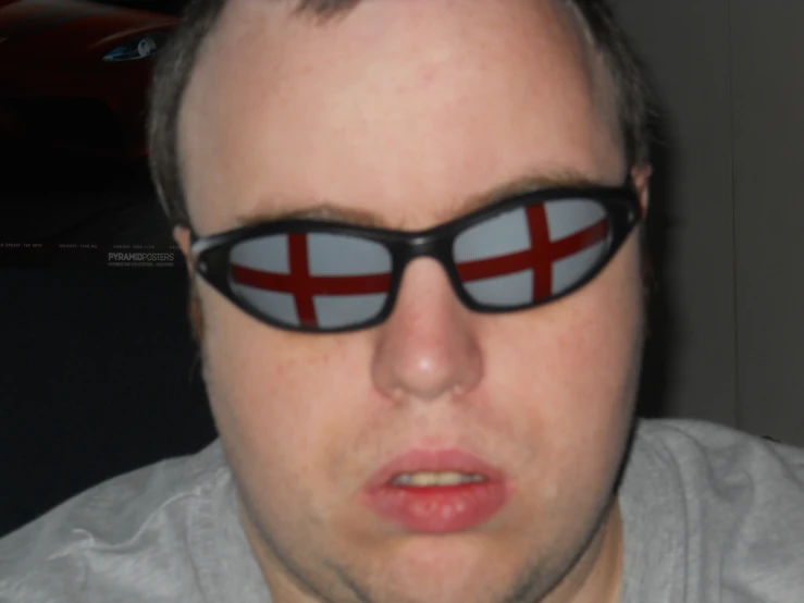 man wearing glasses with flag reflection in them