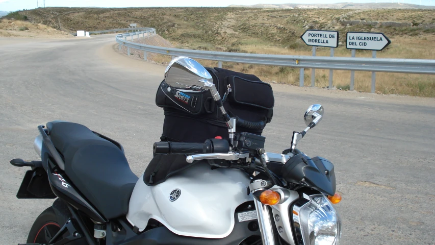 an motorcycle with a helmet and boot is parked on the street