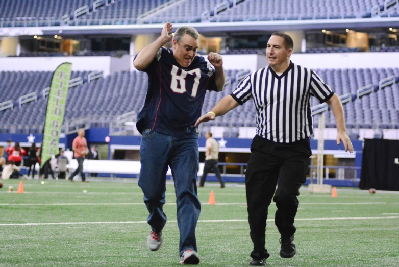 a man is walking next to an official in the field