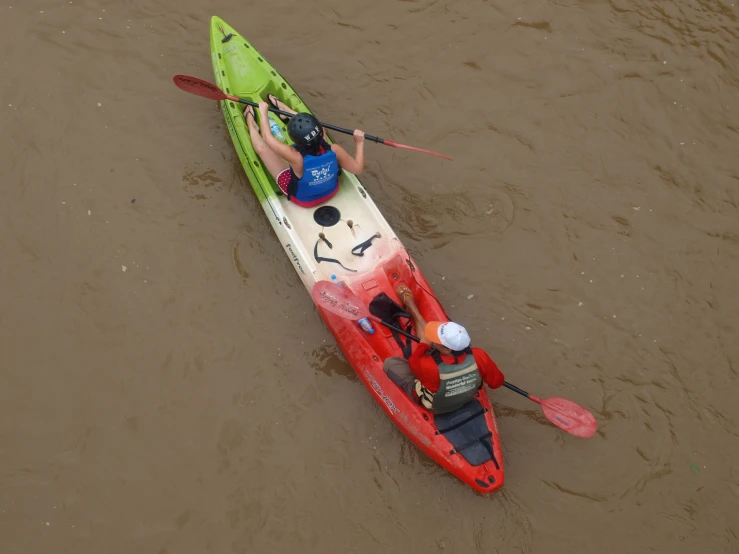 two people are in a kayak with one man on the paddle