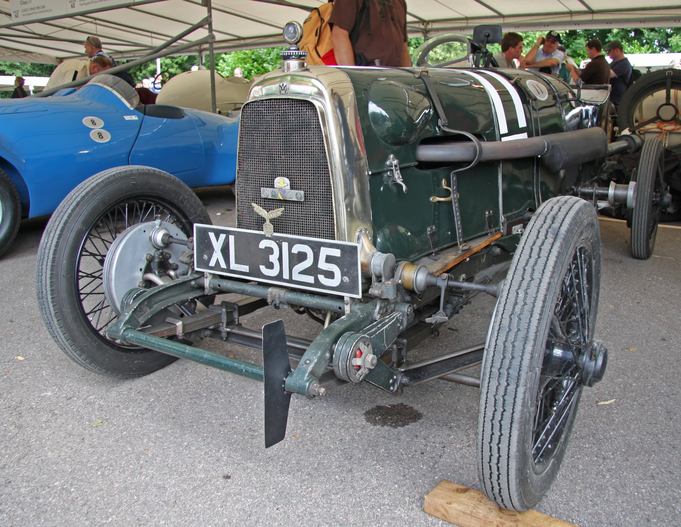 an antique race car on display at a vintage car show