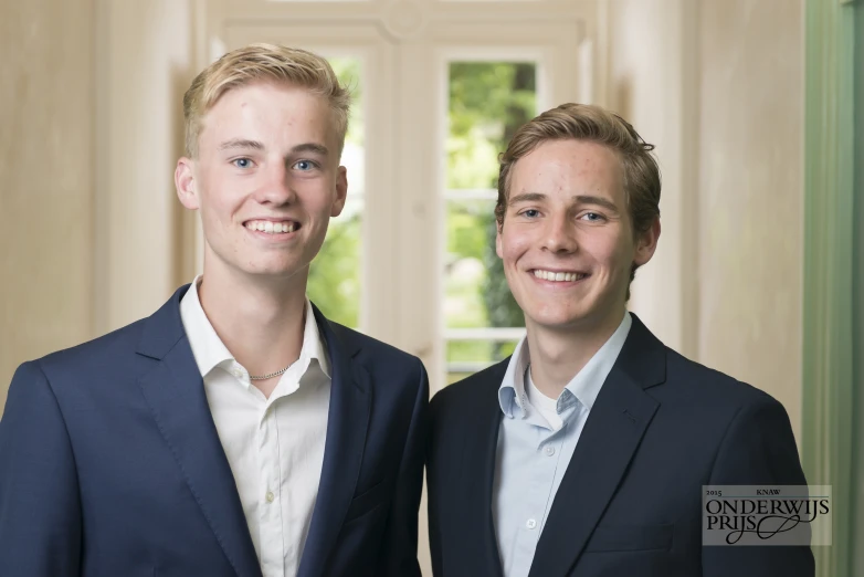 two young men are posing for a portrait