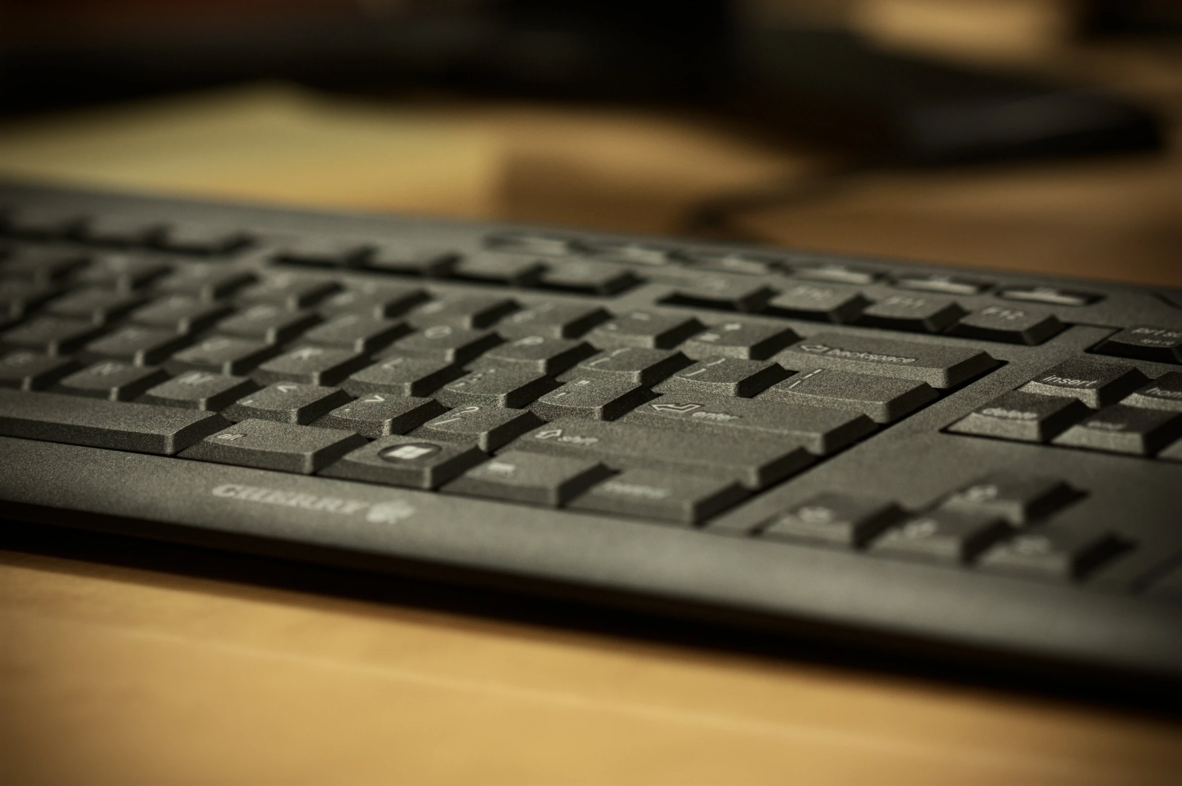 a computer keyboard that is sitting on a desk