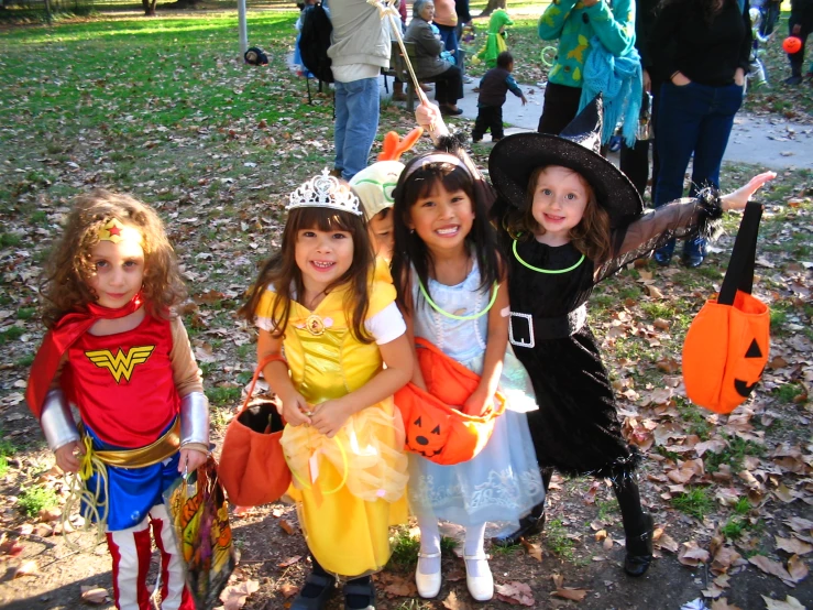 a group of children in costumes posing for the camera