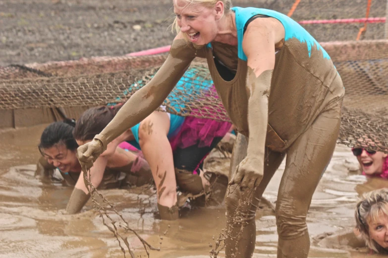 people are playing in mud during a race