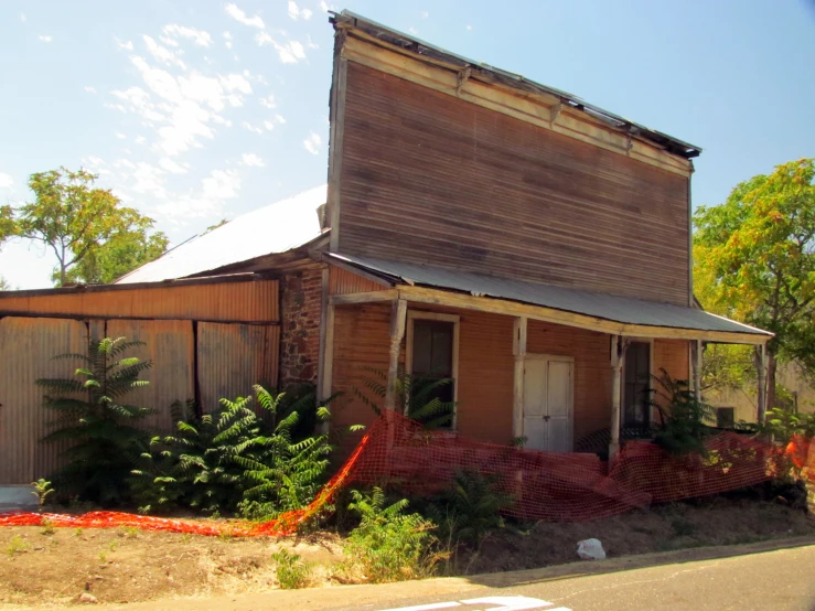 a old house sitting on a street corner next to a red fire hydrant