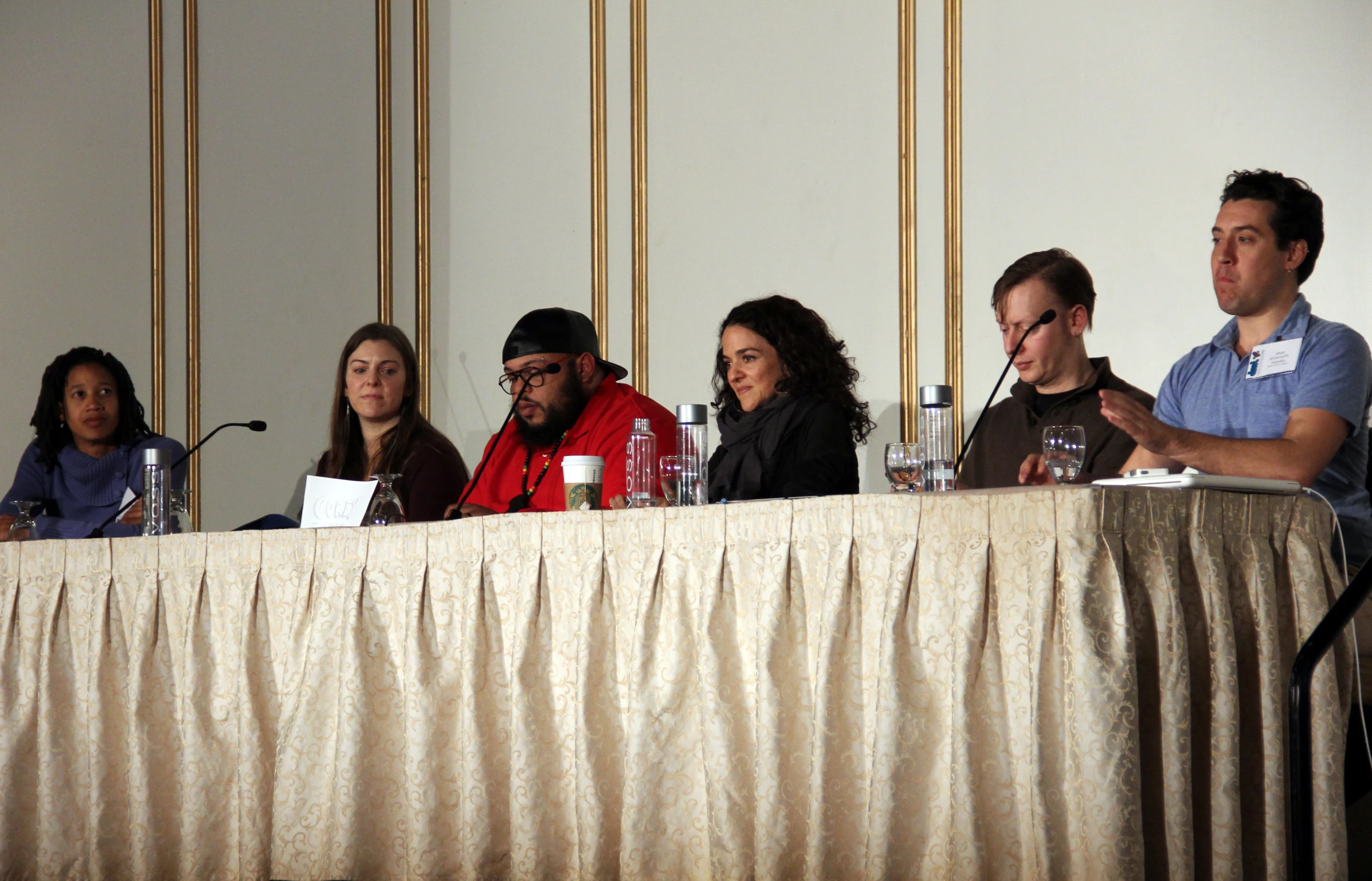 a panel sitting at a long table