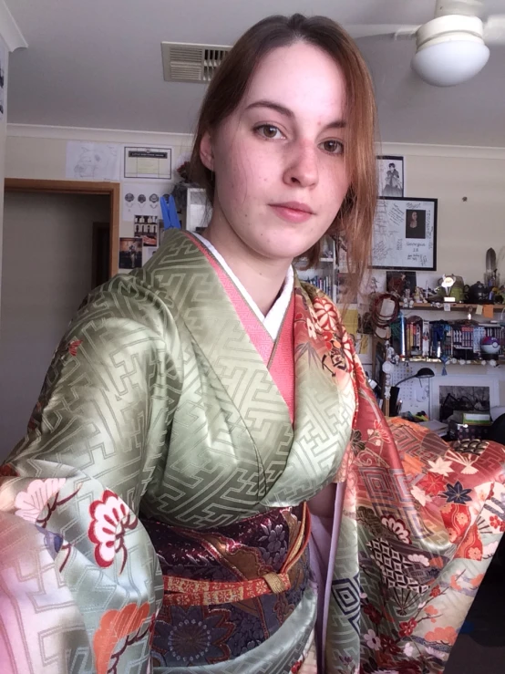 the woman in the kimono is looking at the camera