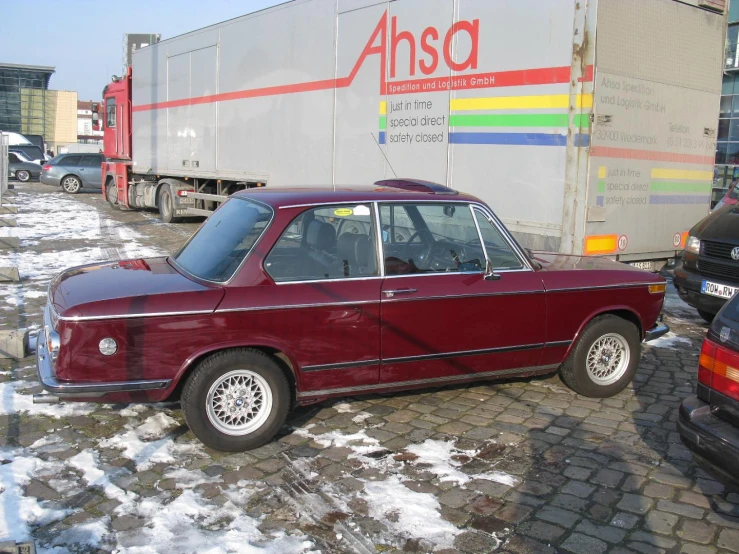 a red car sits in front of other cars