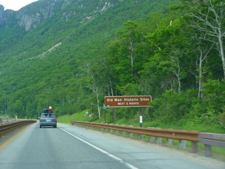 a car that is driving on the road with mountain view