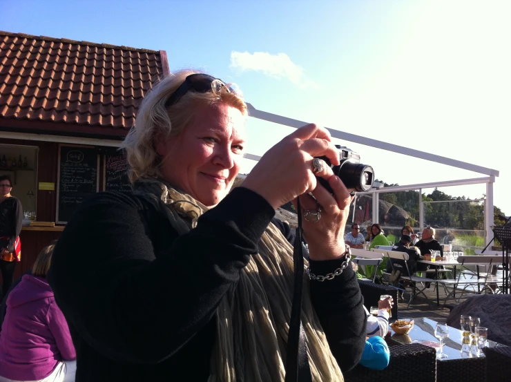 an older woman is taking a picture with her camera