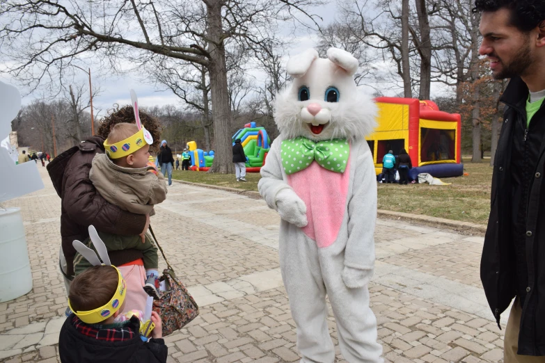 two men standing next to two s wearing costumes