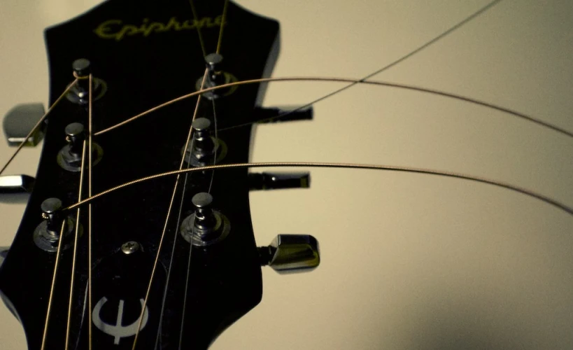 close up of a guitar head and strings