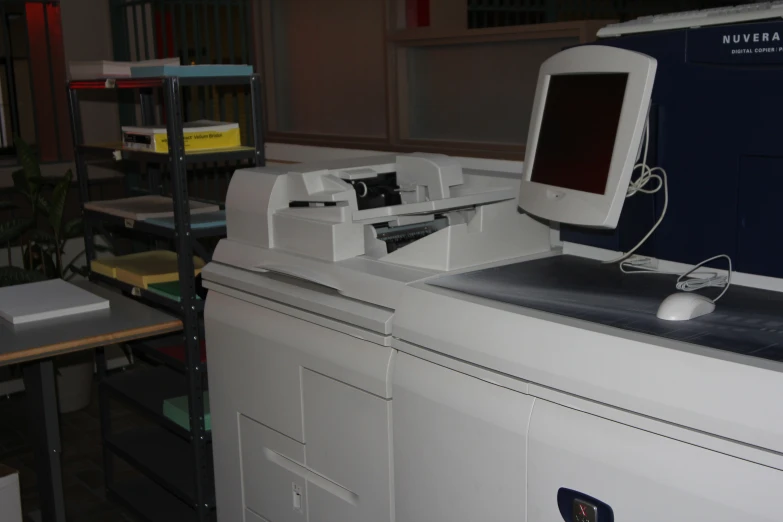 a computer monitor and laptop sit on top of the desk