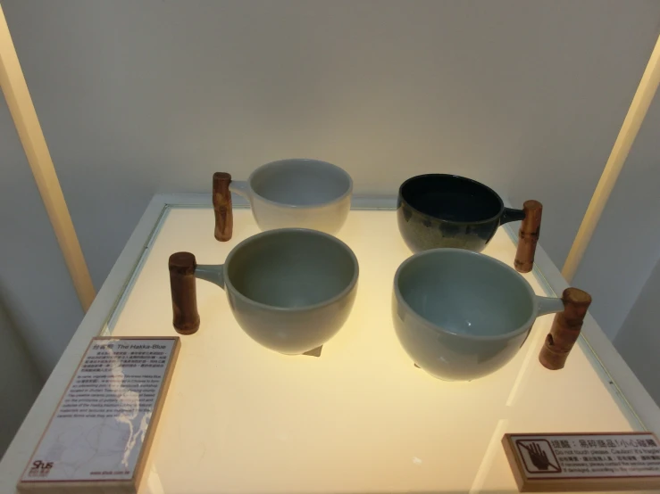 three bowls in varying sizes sit on a display shelf