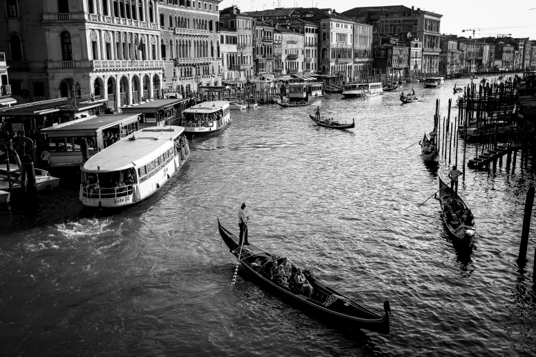 several boats in the water near buildings and a pier