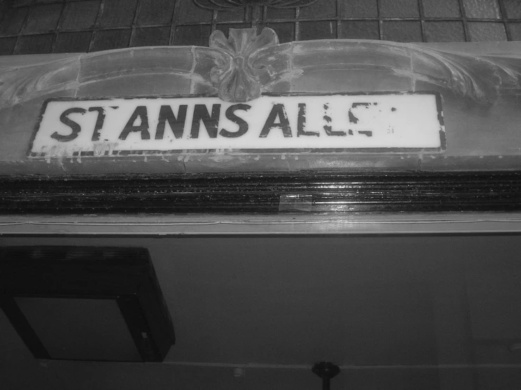 black and white image of an old street sign