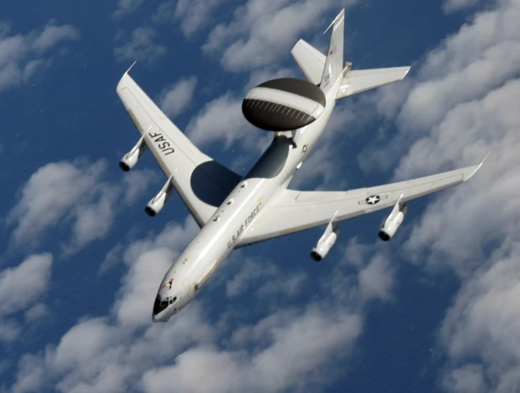 a white jet plane flying through the sky