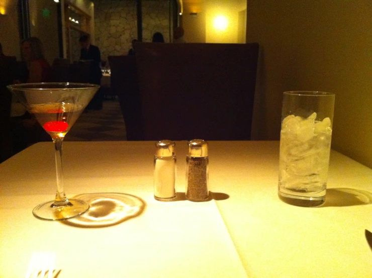 a white table with wine and glasses sitting on top of it