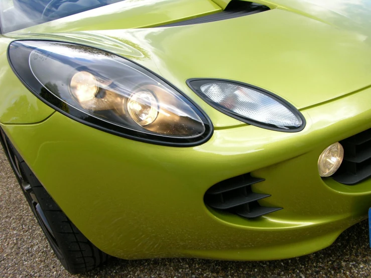 a close up of the front lights of a green car