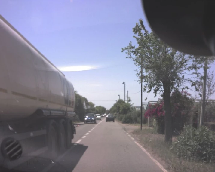 a big truck on a highway in the middle of the day