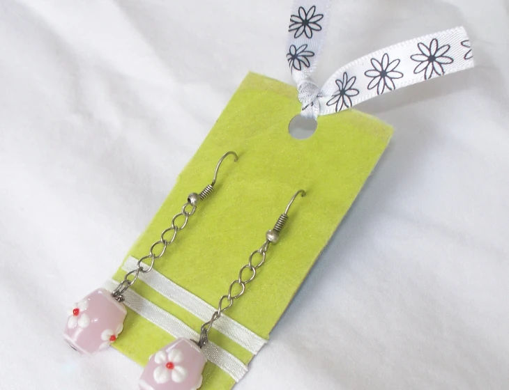 some little pink and white items on a green paper bag