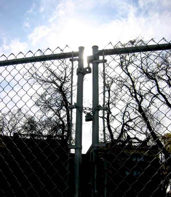 an old train on a track sitting behind a fence