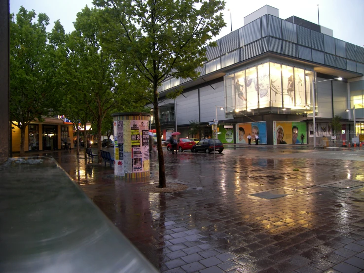 people walk in the rain outside a shopping center