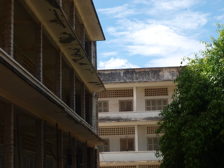 the corner view of a building with the window covered in holes