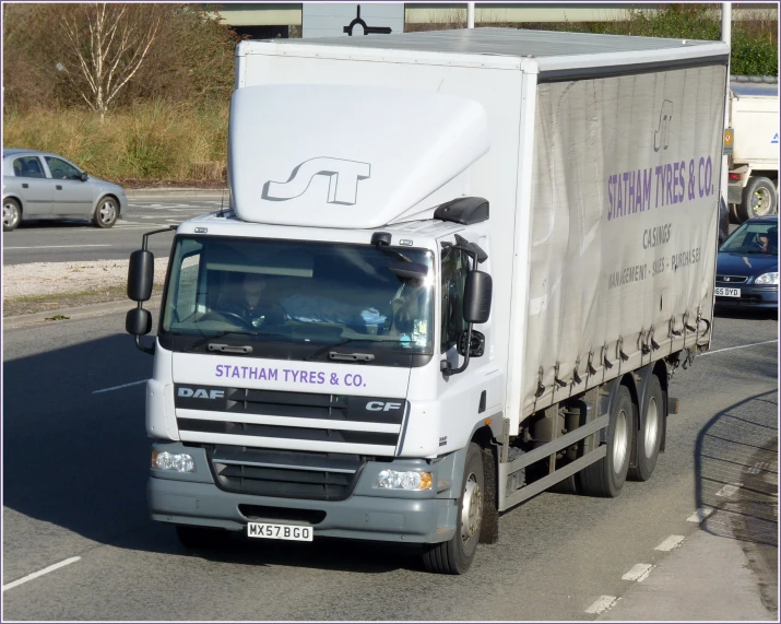 a semi truck with a large box sitting on the street