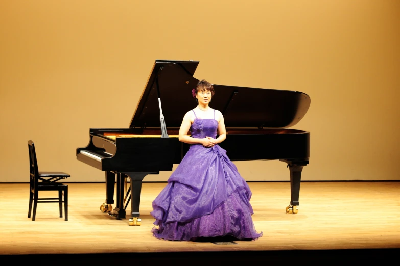 a person standing on a stage in front of a piano