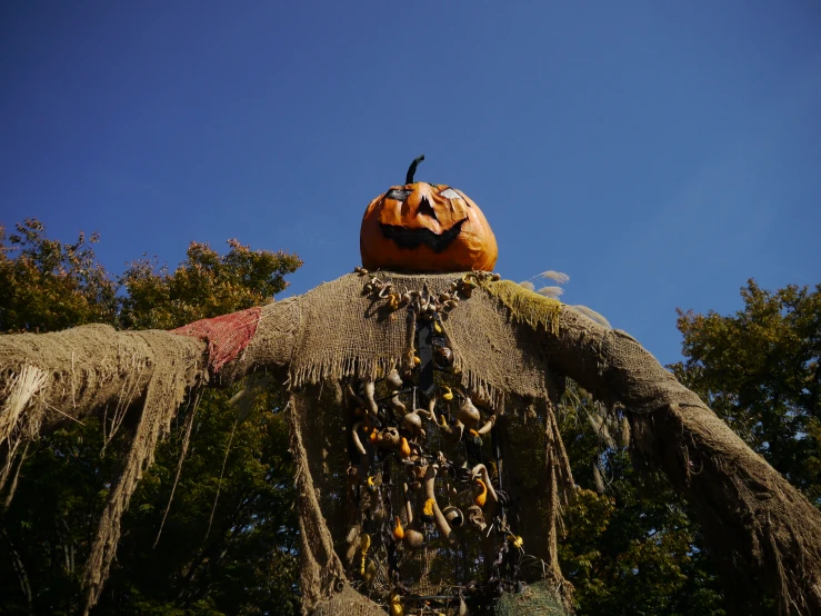 a scarecrow with eyes and arms decorated for halloween