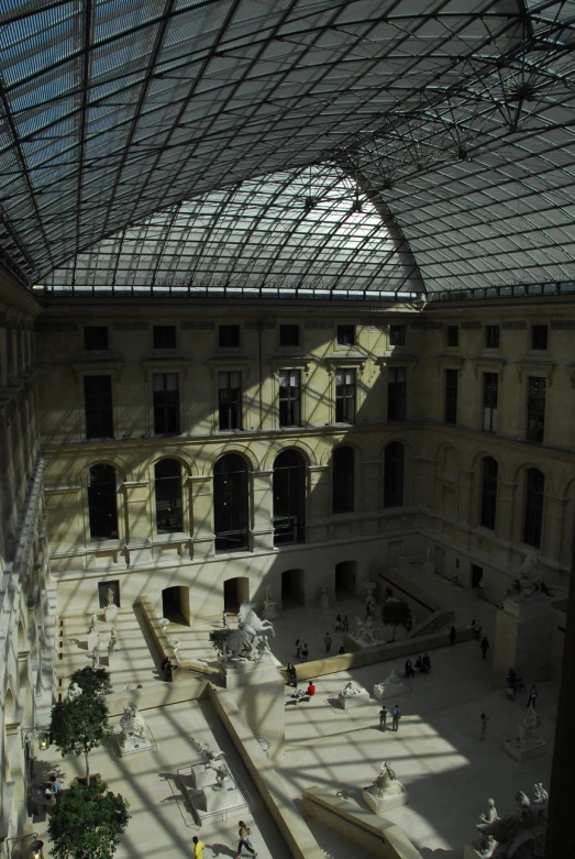 a room full of people standing in an empty building