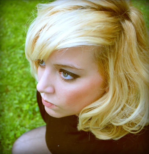 a young blonde woman with blue eyes and long hair